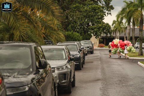 A professional documentary-style family photographer captured this shot in Campo Grande, Mato Grosso do Sul, showcasing children carrying away balloons from a festive celebration.